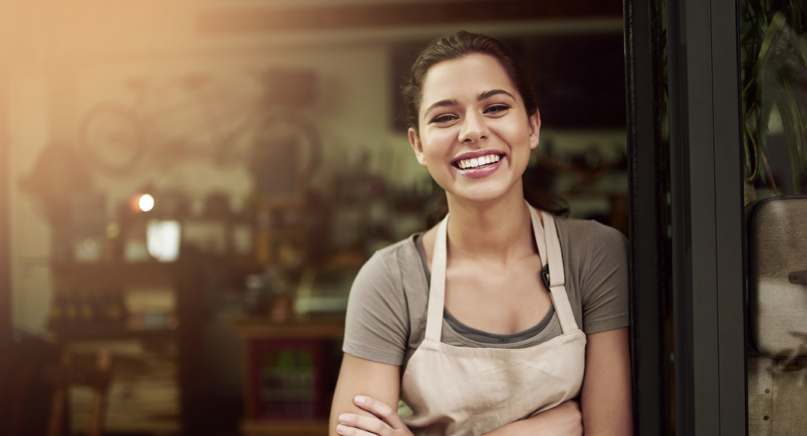 shop owner smiling while opening her business